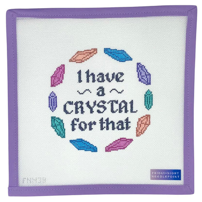 Needlepoint canvas design fabric with colorful crystals and text 'I have a crystal for that' on a white background.