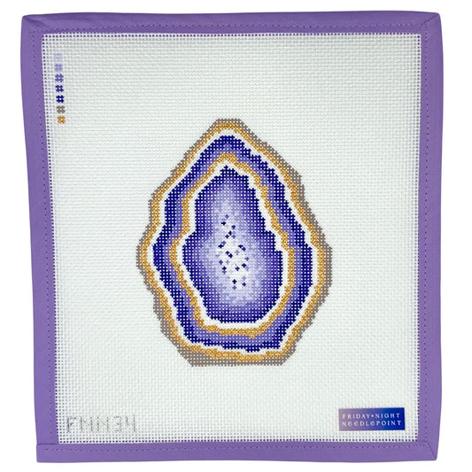 Needlepoint purple geode design on a needlepoint canvas with a purple border.