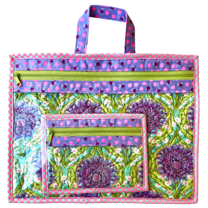 Colorful tote bag with floral pattern and polka dot accents on a white background needlepoint project bag purple daisy quilted