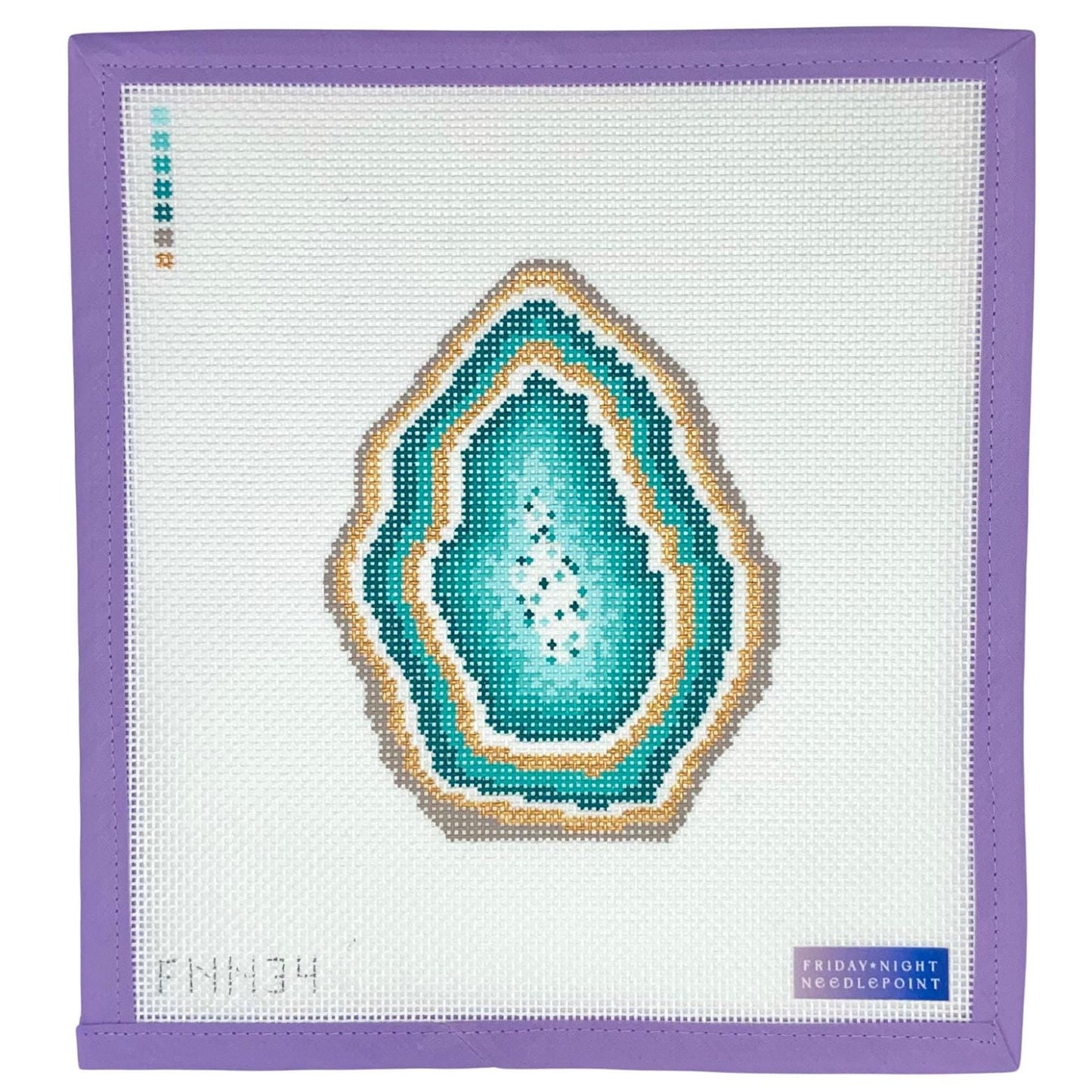 Needlepoint green geode design on a white fabric with purple border, featuring 'Friday Night Needlepoint' branding