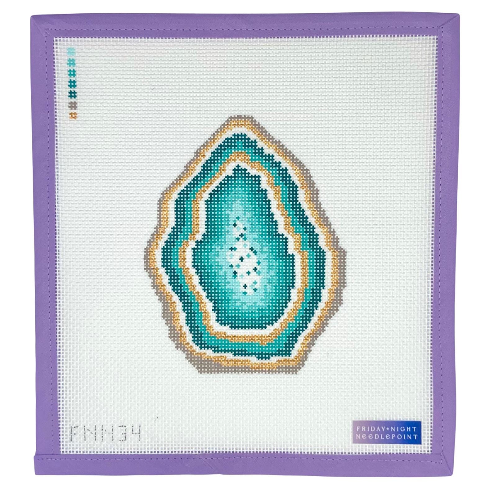 Needlepoint green geode design on a white fabric with purple border, featuring 'Friday Night Needlepoint' branding