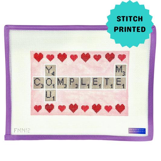 Needlepoint pattern with red hearts and letters on a white fabric with purple border scrabble you complete me